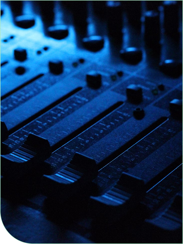 audio mixing console faders corporate event production raleigh - Audio/Video Services for Corporate Events in the Triangle Close-up of professional audio mixing console faders and knobs under blue stage lighting for corporate event production by Unstoppable Events in Raleigh North Carolina